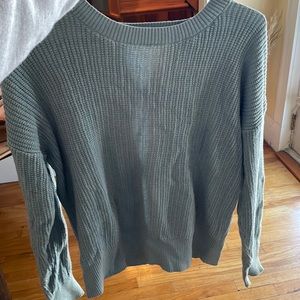 Small light blue sweater, open detailed back